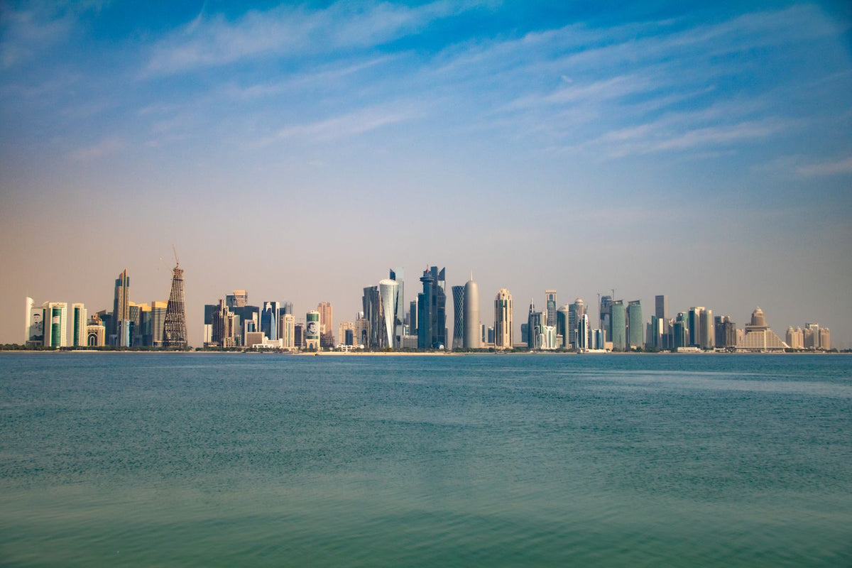 Doha's West Bay skyline seen from the Corniche under a clear blue sky