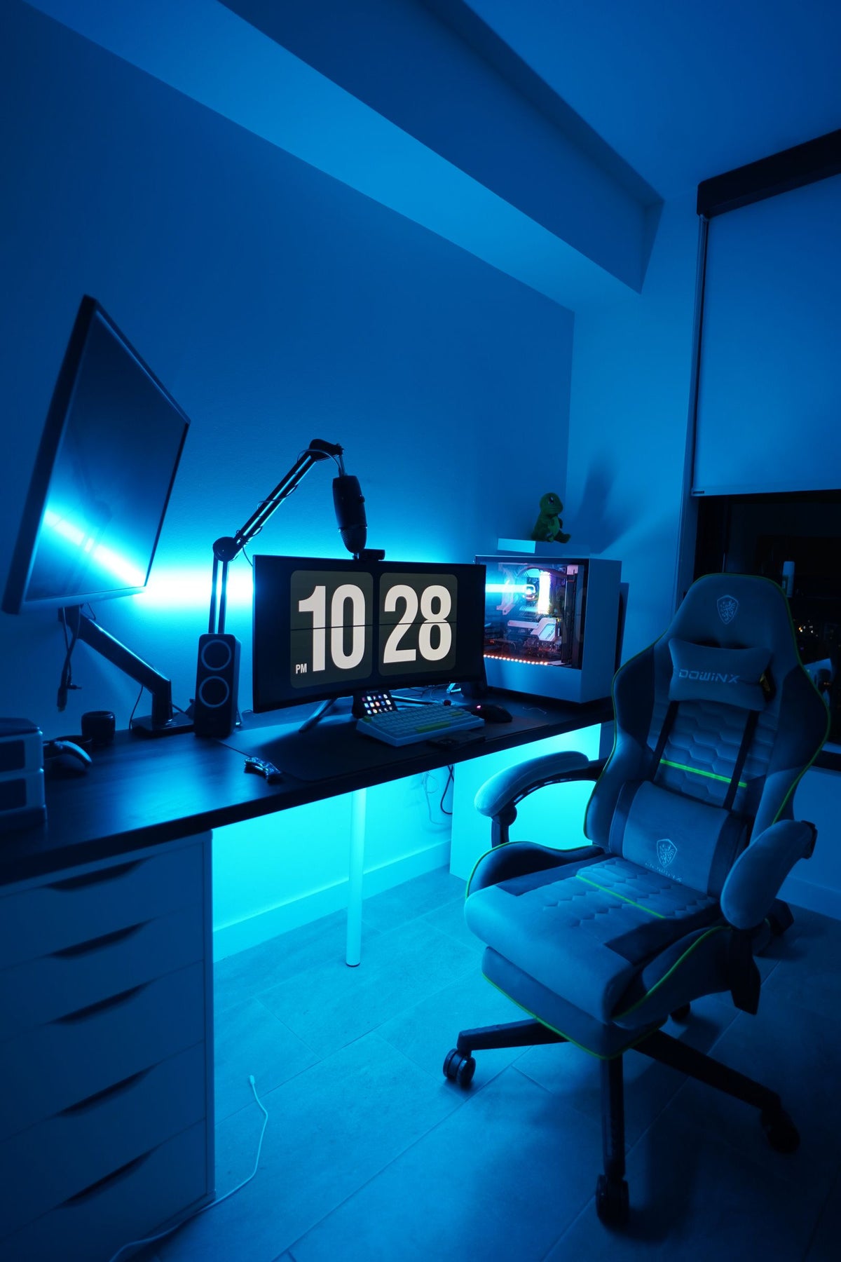Gaming workstation with dual monitors lit in blue light, representing game development and digital content creation in Doha