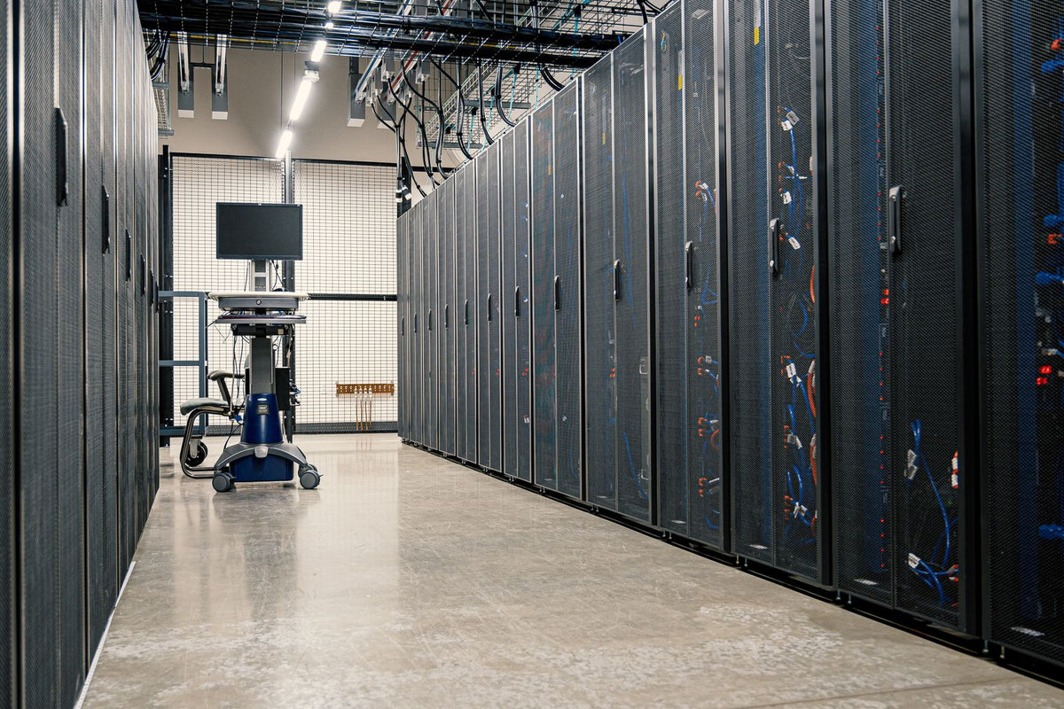 Corridor of server racks and networking cabinets inside a modern data centre