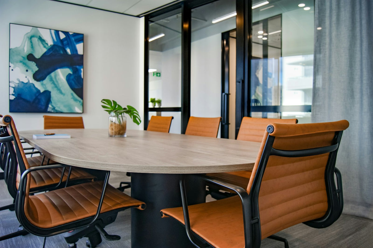 Empty boardroom with a long wooden conference table and chairs, representing family-business governance and investment committees