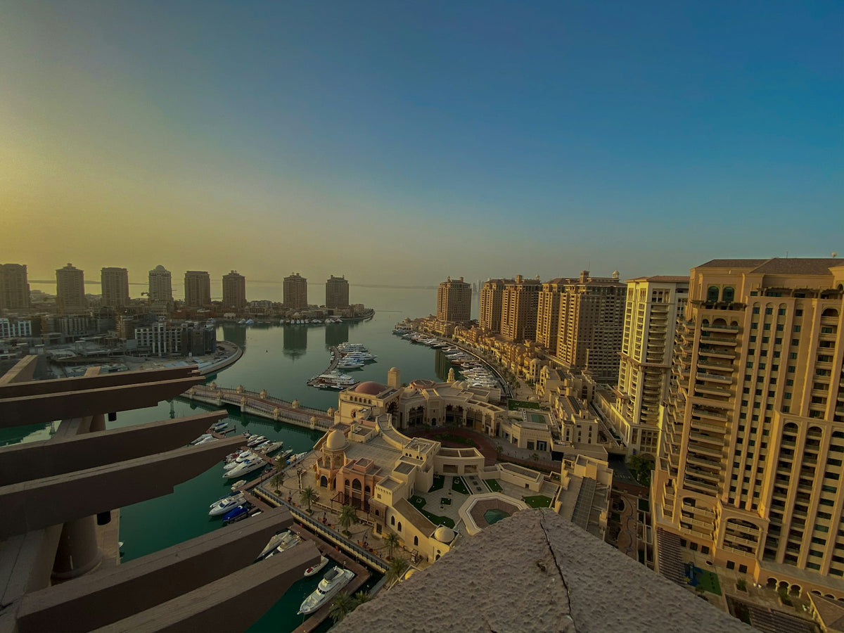 Aerial view of The Pearl in Doha, Qatar, with residential towers and marinas on the waterfront