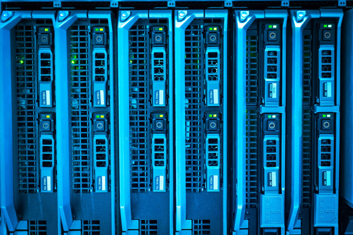 Close-up of illuminated server racks glowing blue in a data centre