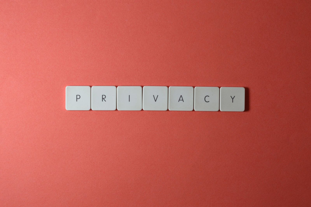 Letter tiles spelling PRIVACY on a red background, representing personal data protection