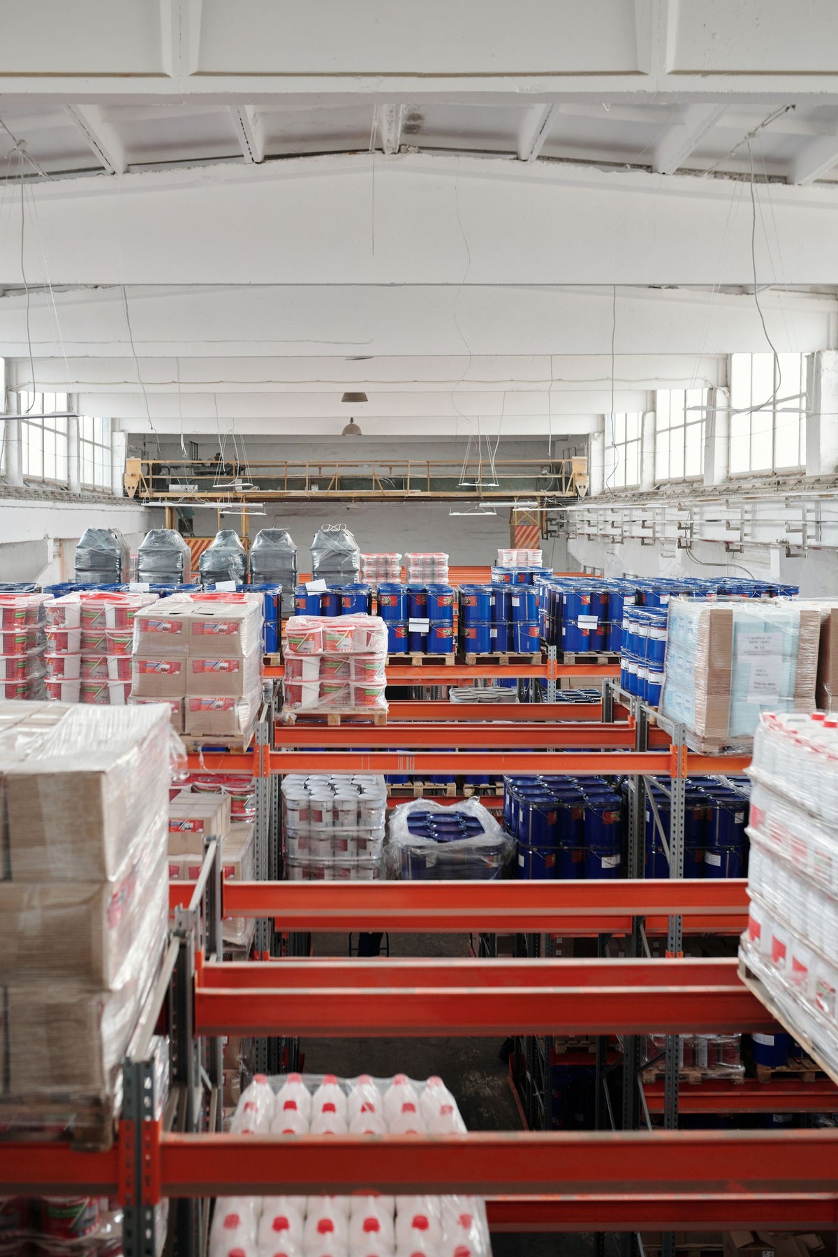 Rows of tall warehouse shelving stacked with goods ready for shipment