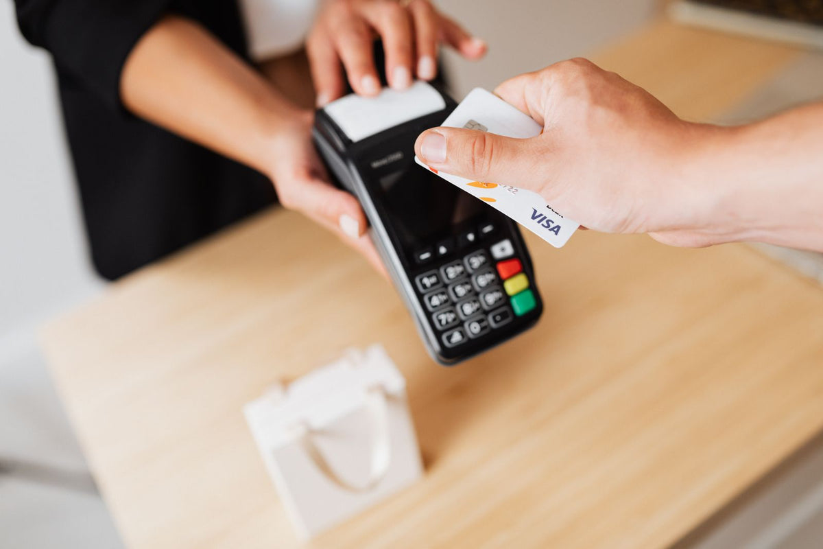 Close-up of hands making a contactless card payment on a payment terminal
