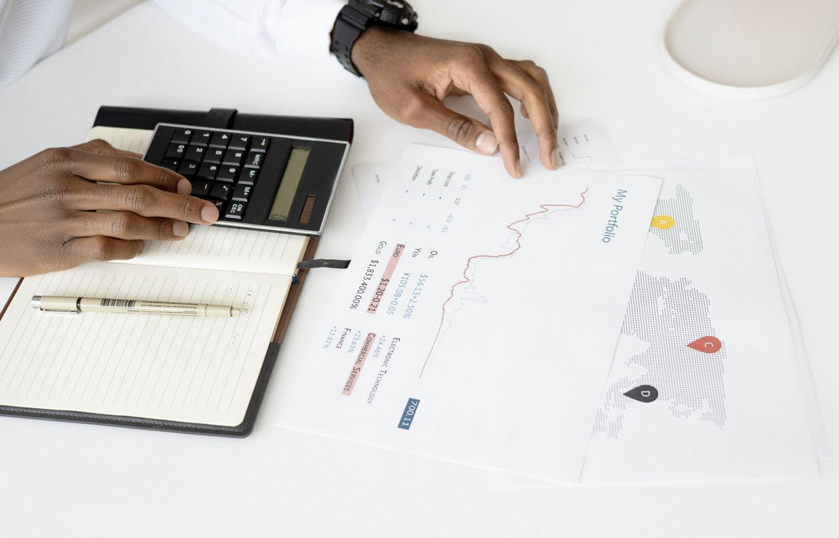 Overhead view of financial documents and a calculator on a desk during a business review