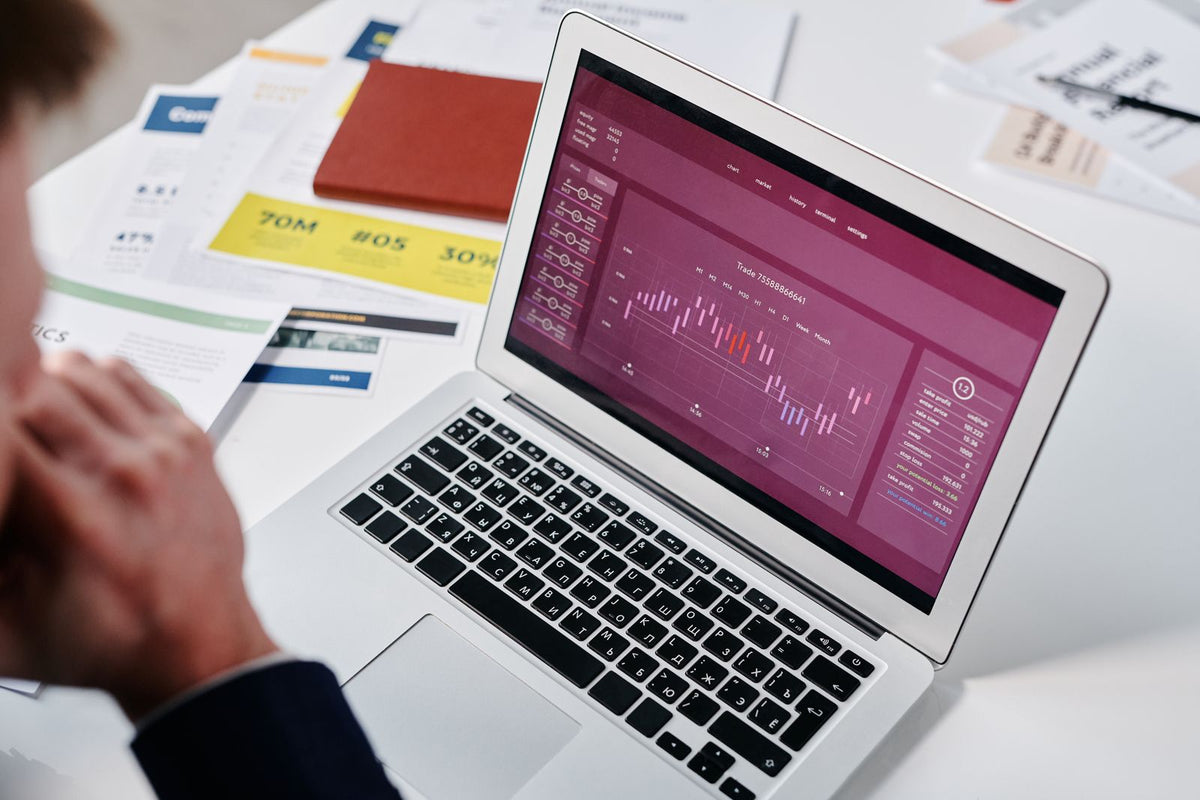 Purple data chart displayed on a laptop screen in an office, representing startup performance metrics