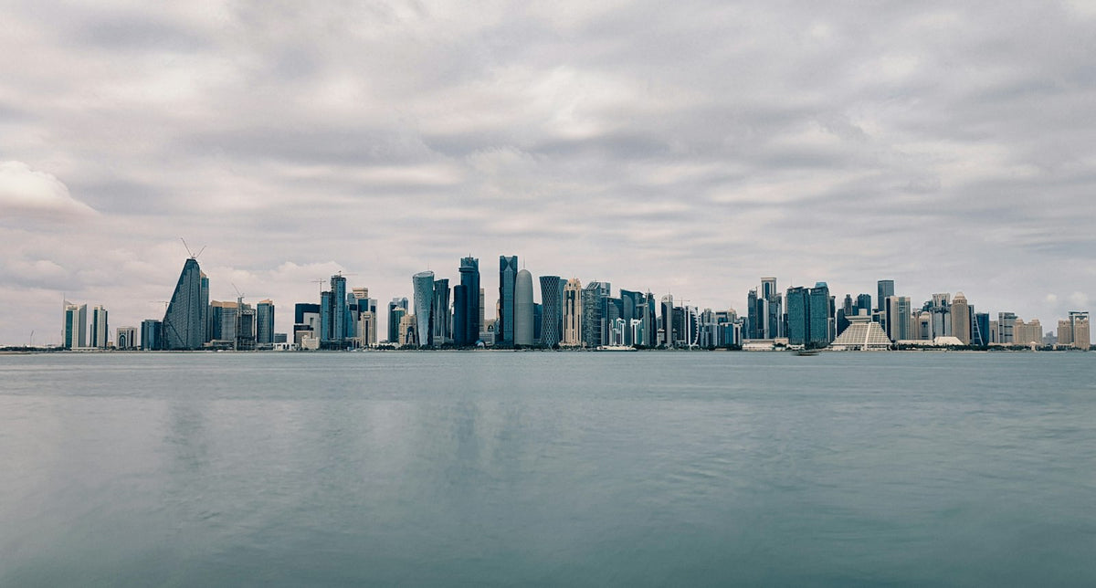 Doha's high-rise skyline seen across the water, home to Qatar's mainland, QFC and free zone businesses